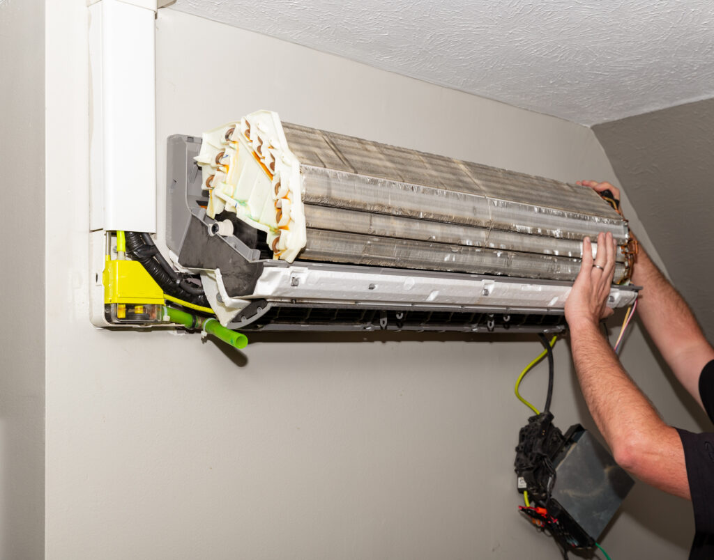 mini split air conditioner system on wall, being fixed